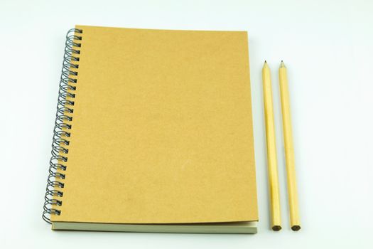 close notebook with pencil on white background