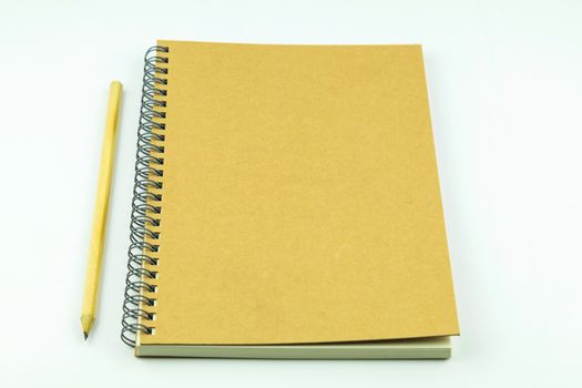 close notebook with pencil on white background