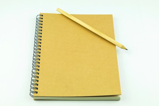 close notebook with pencil on white background