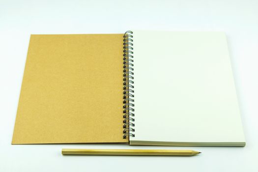 open notebook cover with pencil on white background