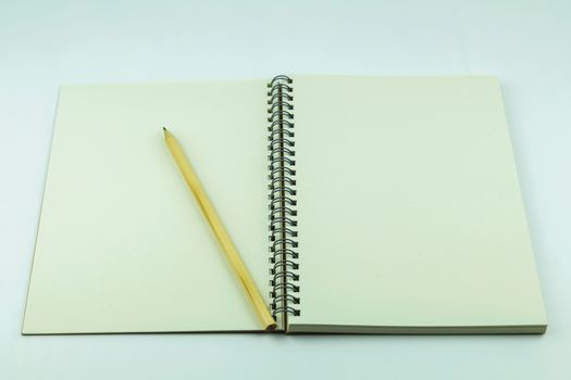 open notebook with pencil on white background