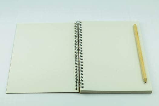 open notebook with pencil on white background