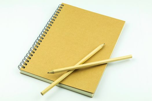close notebook with pencil on white background