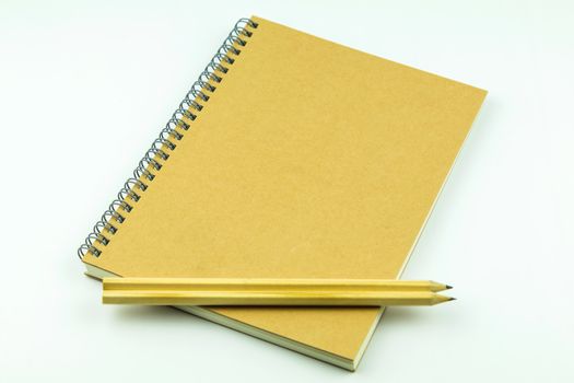 close notebook with pencil on white background