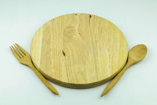 wood cutting board with spoon and fork on white background