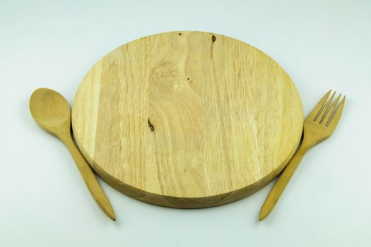 wood cutting board with spoon and fork on white background