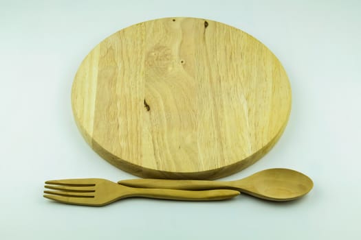 wood cutting board with spoon and fork on white background