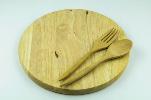 wood cutting board with spoon and fork on white background