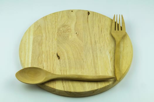 wood cutting board with spoon and fork on white background