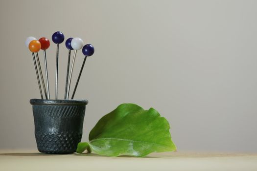 Thimble and pins similar to the a bouquet of flowers in a pot