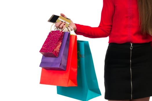 Woman holding colourful shopping paper bags, packages and banking credit card in her hand
