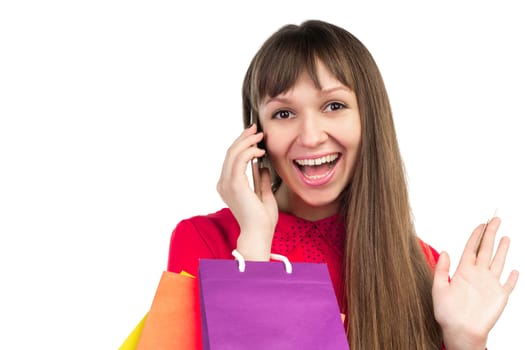 Young woman with banking credit card, colourful shopping paper bags and packages, smartphone