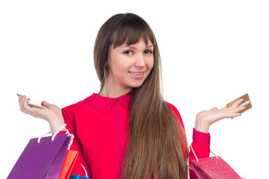 Young woman with banking credit card, colourful shopping paper bags and packages, smartphone