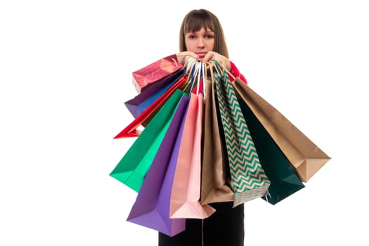 Close-up of shopping purchases, many colorful paper bags, packages in female hands