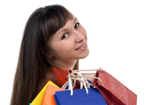 Close-up of smiling young woman face with colourful shopping paper bags