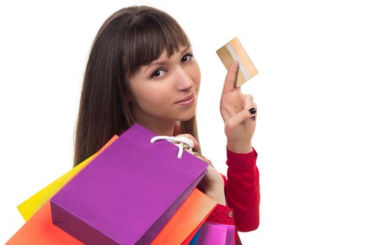 Young woman shopping with credit card holding colourful paper bags and packages