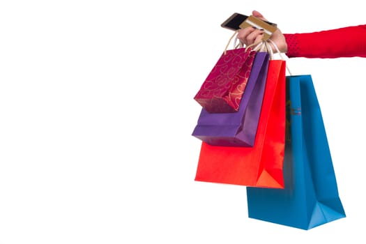 Woman holding colourful shopping paper bags, packages and banking credit card in her hand