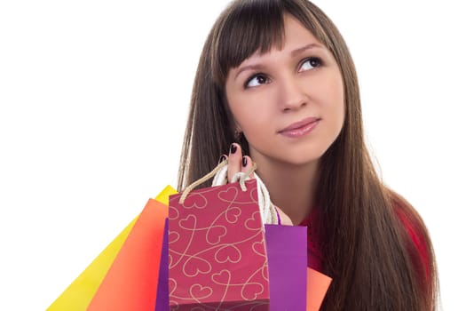 Close-up of smiling young woman face with colourful shopping paper bags