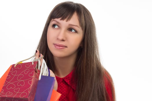 Close-up of smiling young woman face with colourful shopping paper bags