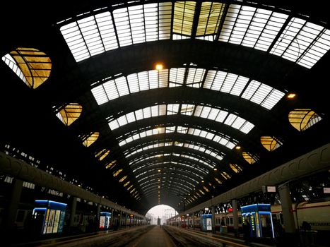 Architectural detail in Milan Central Station in Milan, Italy. Low angle view with dark shades and natural light from top.