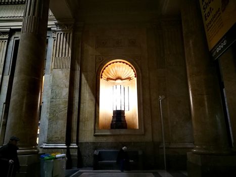 Architectural detail in Milan Central Station in Milan, Italy. Low angle view with dark shades and natural light from top.