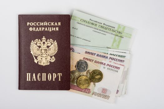 Passport, insurance certificate and money on a white background