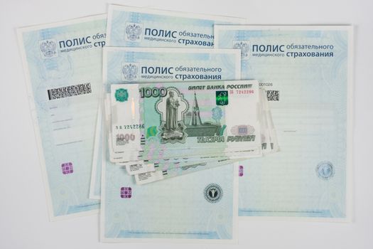 Russian money is on the policy of compulsory medical insurance, white background