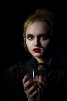 Young girl vampire on a black background