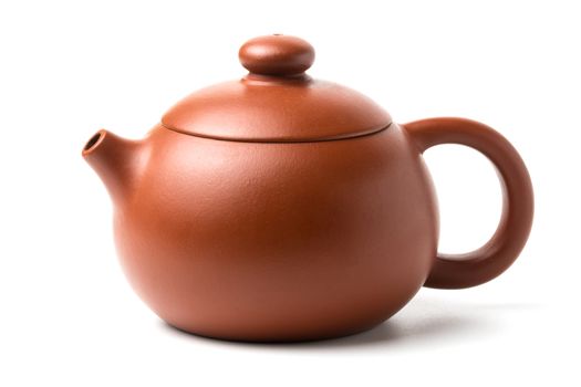 Small brown earthenware teapot with closed lid isolated on white background