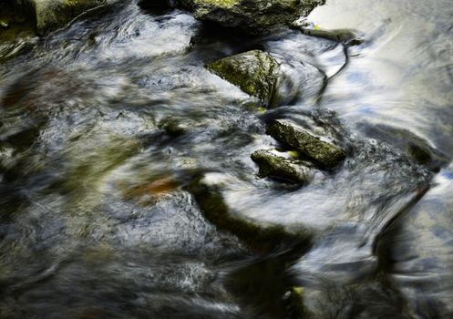 abstract background autumn dark detail river with rocks