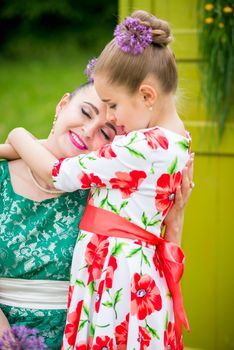 mother with daughter have a breakfast in the garden