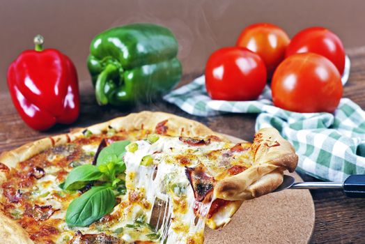 Italian homemade pizza with bacon on a wooden table