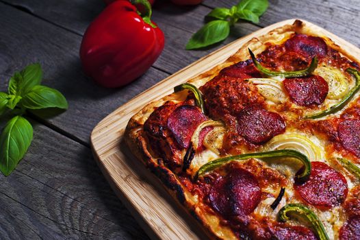 Italian homemade pizza with pepperoni on a wooden table