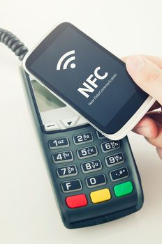 Contactless payment card with NFC chip in smart phone