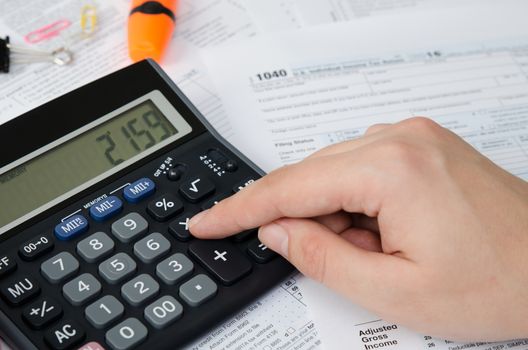 Man calculates income tax. tax form us calculate income office hand refund concept