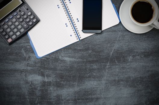 Business desk in office top view. Table with calculator, coffee, notepad, smartphone, and office supplies. Copy space website banner concept