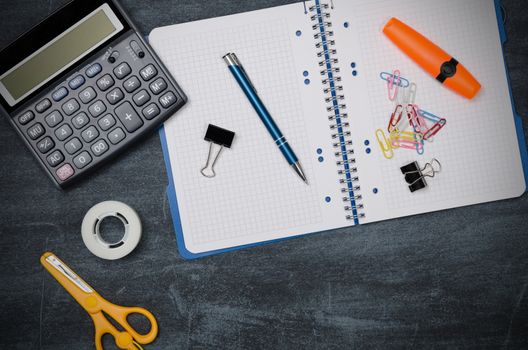 Business desk in office top view. Table with calculator, notepad, and office supplies. Copy space website banner concept