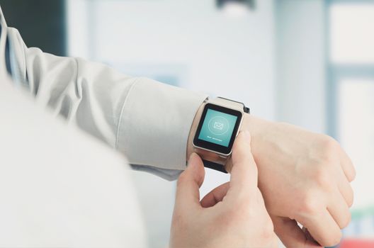 Man using smartwatch with e-mail notifier. smartwatch hand device notify computer internet message e-mail concept