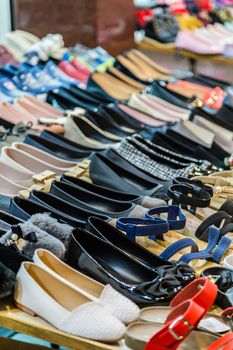 Rows of shoes on a table, casual and formal