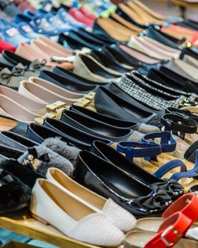 Rows of shoes on a table, casual and formal