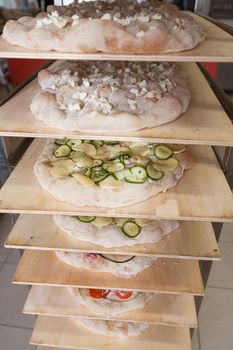 Various cooked romana pizza on a rack