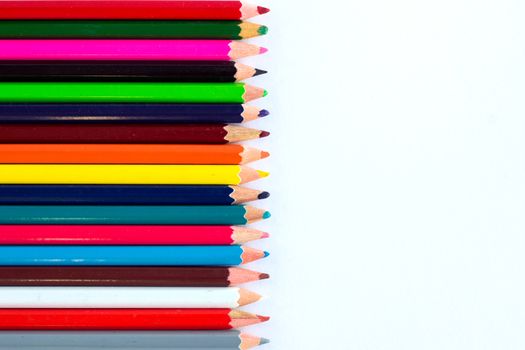 White background for presentation with vertical colourful right border of multicoloured wooden pencils