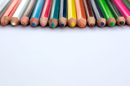 White background for presentation slide with colourful wooden pencils
