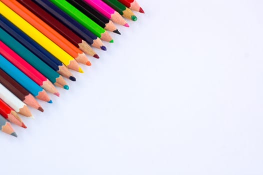 White background for presentation with colourful right upper corner of multicoloured wooden pencils