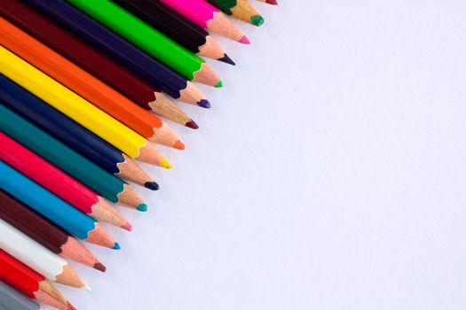 White background for presentation with colourful right upper corner of multicoloured wooden pencils