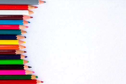 White background for presentation with vertical colourful right round border of multicoloured wooden pencils