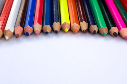 White background for presentation slide with colourful wooden pencils