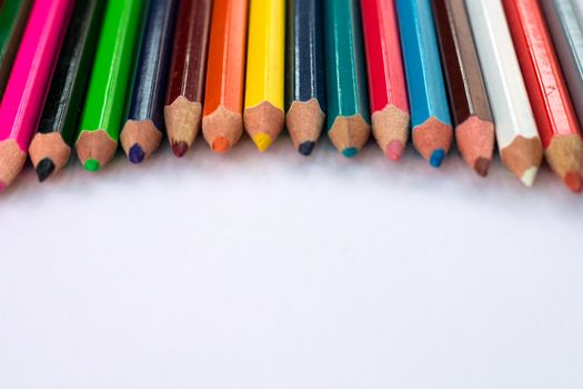 White background for presentation slide with colourful wooden pencils