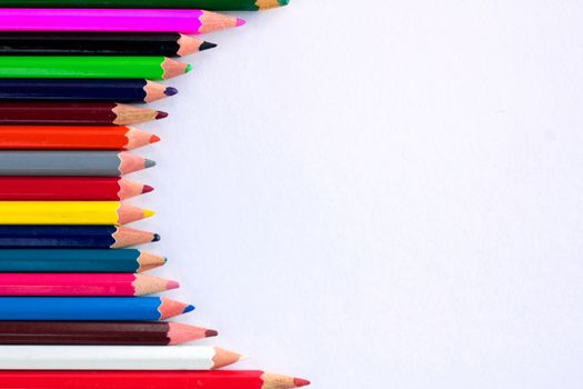 White background for presentation with vertical colourful right round border of multicoloured wooden pencils