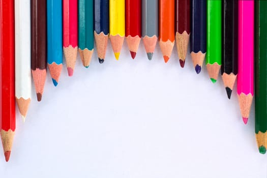 White background for presentation with round horizontal colourful upper border of multicoloured wooden pencils
